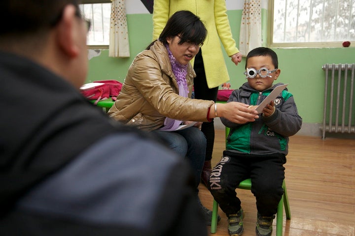 A child takes an eye exam administered by REAP and CEEE.