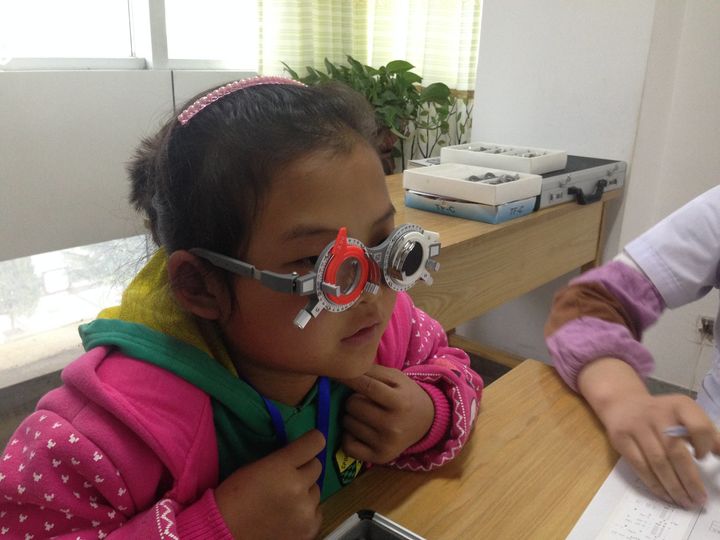 A girl gets tested for her first glasses prescription.