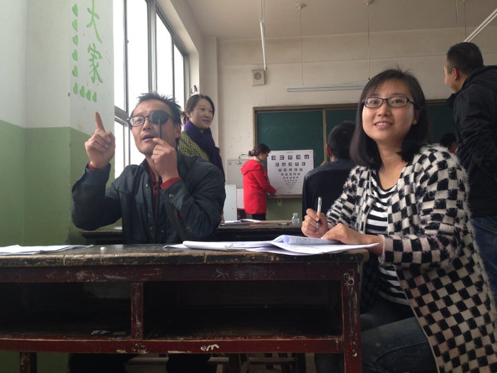 Teachers in Wang Yao village practice administering eye exams.