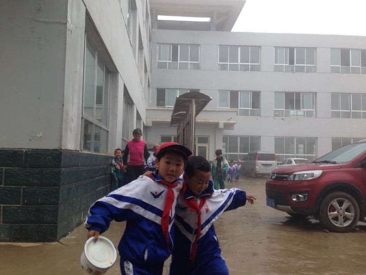 Students hurry to lunch at a school in Wang Yao Village.