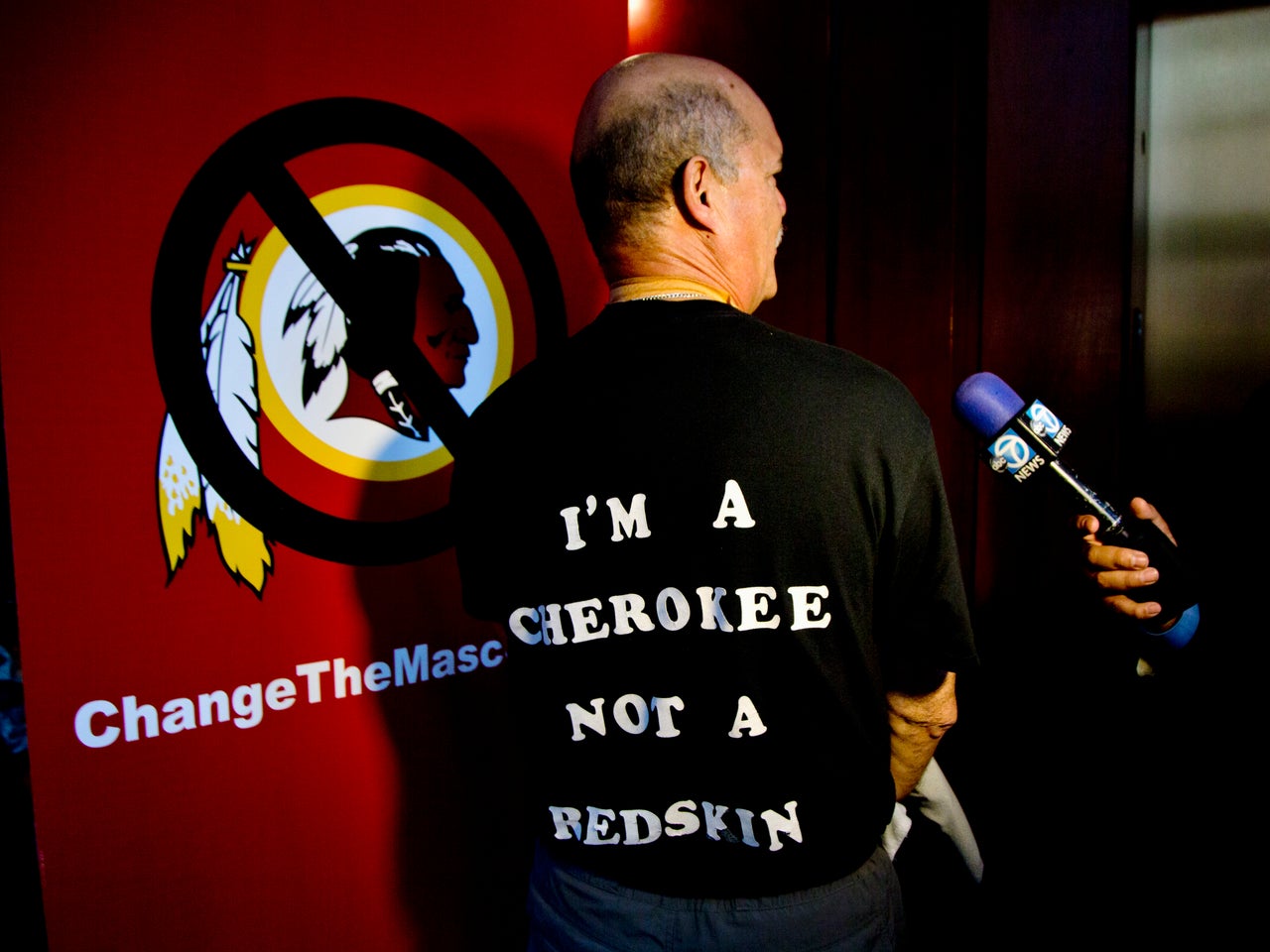 Verlin Deer In Water, a member of the Cherokee Nation of Oklahoma shows his t-shirt during an interview in Washington, Monday, Oct. 7, 2013, calling for the Washington Redskins NFL football team to change its name.