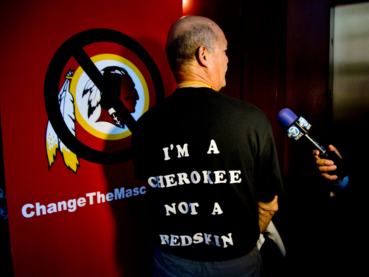 Verlin Deer In Water, a member of the Cherokee Nation of Oklahoma shows his t-shirt during an interview in Washington, Monday, Oct. 7, 2013, calling for the Washington Redskins NFL football team to change its name. 