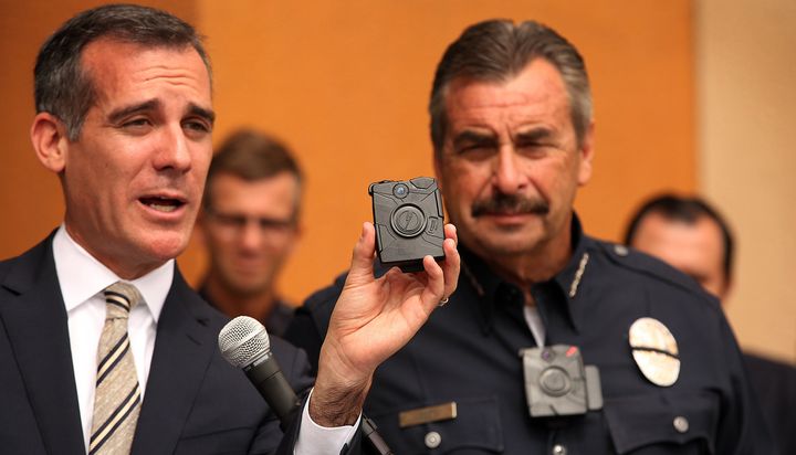 Los Angeles Mayor Eric Garcetti, left, with LAPD Chief Charlie Beck, right, who is wearing a body camera, shows off the new LAPD body camera on Sept. 4, 2015.