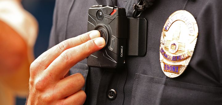 An LAPD officer demonstrates how to use one of the department's new body cameras during a Sept. 4 press conference.