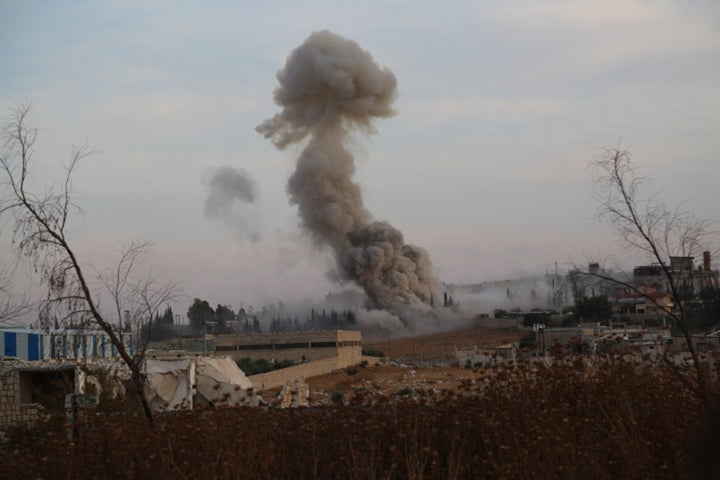 Smoke rises after Russian airtrikes hit ammunition-stores and bases of two opposition groups, in Mansoura region in the west