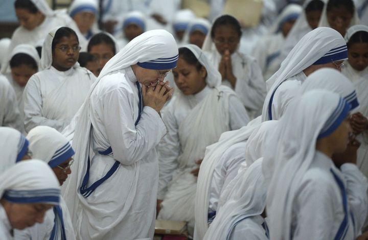 Nuns of the Missionaries of Charity pray at the tomb of Mother Teresa in the Mother House in Kolkata, India on September 15, 2015.