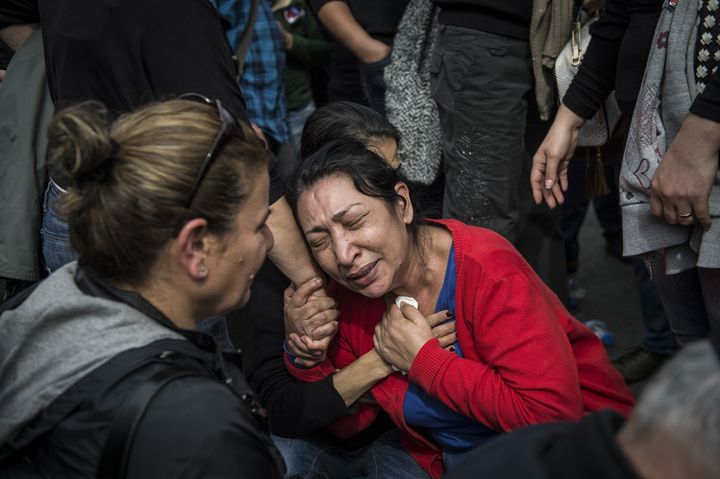 People react as they gather on Oct. 11, 2015, at the scene of an attack the day before in Ankara, Turkey.