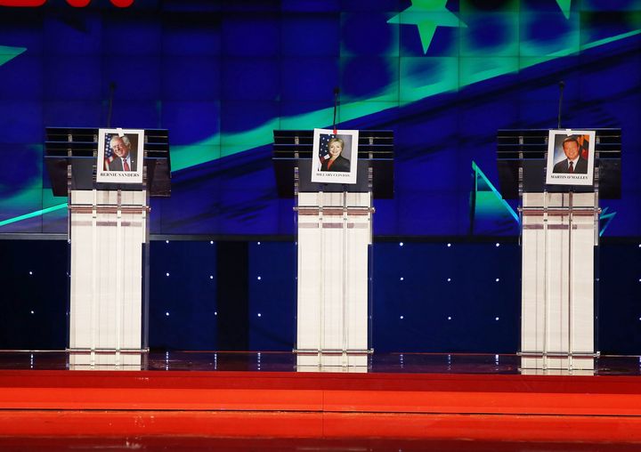 Photographs of Democratic presidential candidates hang on their lecterns in Las Vegas before the party's first primary debate. A new HuffPost/YouGov poll finds that most Democratic voters don't expect the debate to change their minds.