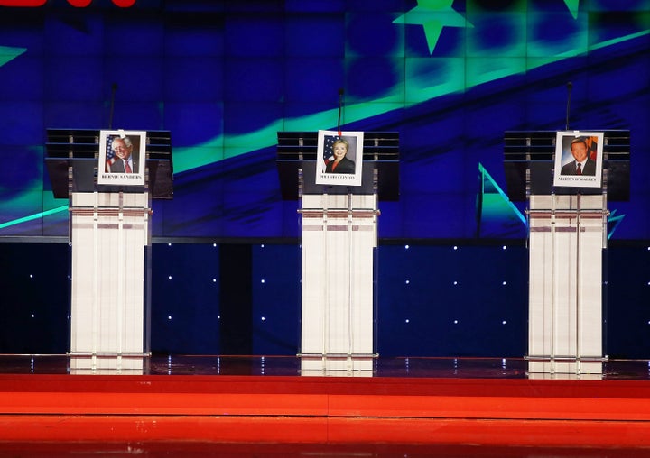 Photographs of Democratic presidential candidates hang on their lecterns in Las Vegas before the party's first primary debate. A new HuffPost/YouGov poll finds that most Democratic voters don't expect the debate to change their minds.