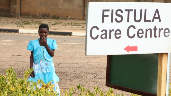 Mary, a fistula patient, stands outside a clinic in Malawi. 