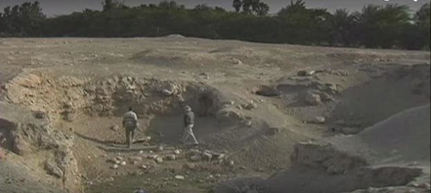 Researchers walk along the site of Tal el-Hammam.