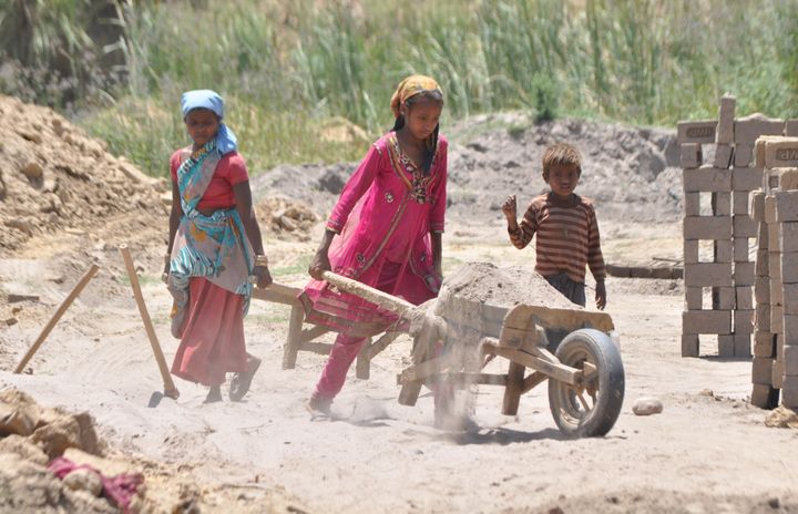 JAMMU, INDIA - 2015/06/11: An Indian girl, Kavita (12 years old), works along with her family at a brick kiln in outskirts of Jammu on the eve of The World Day against Child Labor, which is intended to foster the worldwide movement against child labor in any of its forms. (Photo by Pacific Press/LightRocket via Getty Images)