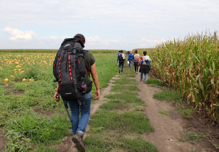 Hiba Dlewati walks with a group of Syrian men, women and children from war-torn Kobani as they trek to the Serbia-Hungary bor