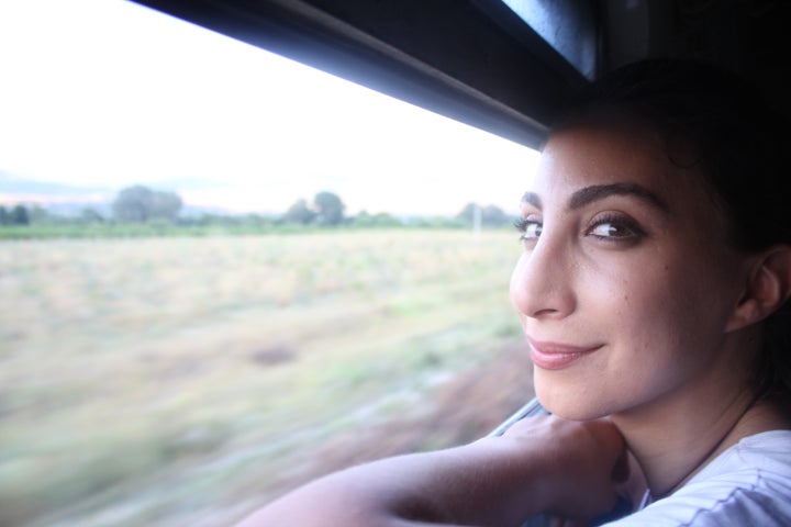 Hiba looks out of the window on a train carrying thousands of refugees from Macedonia's border with Greece toward Serbia. Riot police manned the train station, only allowing some of the people there, who had been waiting for days without any shelter, to board. People at several stops after that hopped on the train to dodge the authorities.