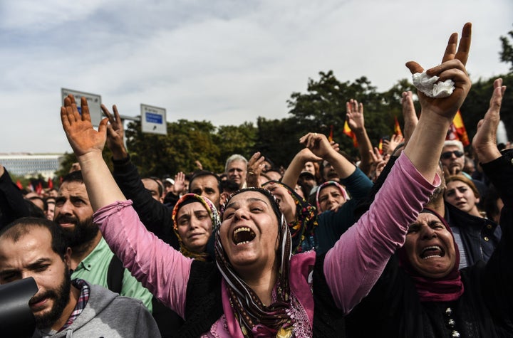 People express their grief as they gather in Ankara a day after the city was struck by deadly twin bomb attacks.