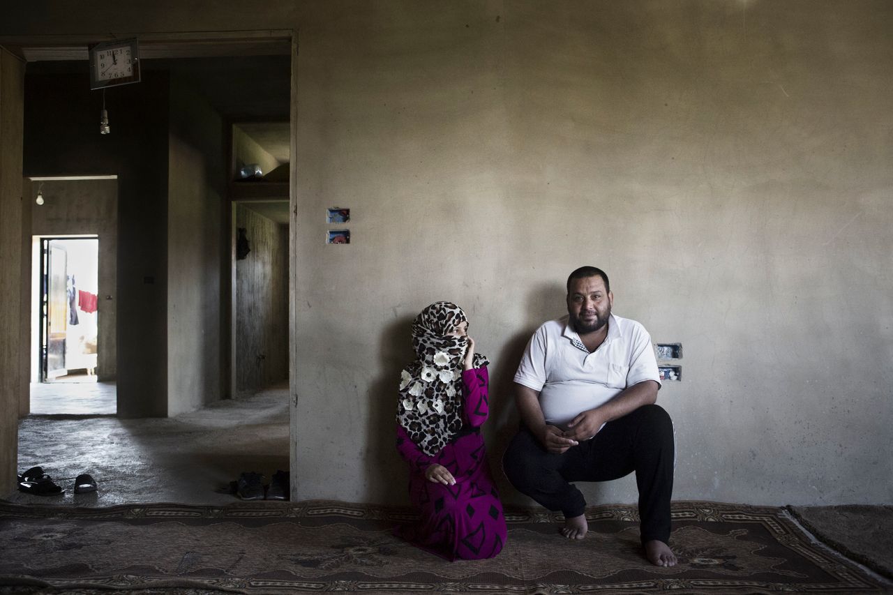 Nour, 13, sits with her 27-year-old husband inside their dwelling in Jeb Janine, Bekaa Valley. Nour and her family, who are refugees from Raqqa Governorate, fled their homeland four years ago.