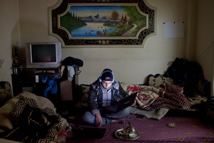 An activist at work in a media centre in the district of Baba Amr in Homs, a few hours before it was shelled.&nbsp;Panos phot