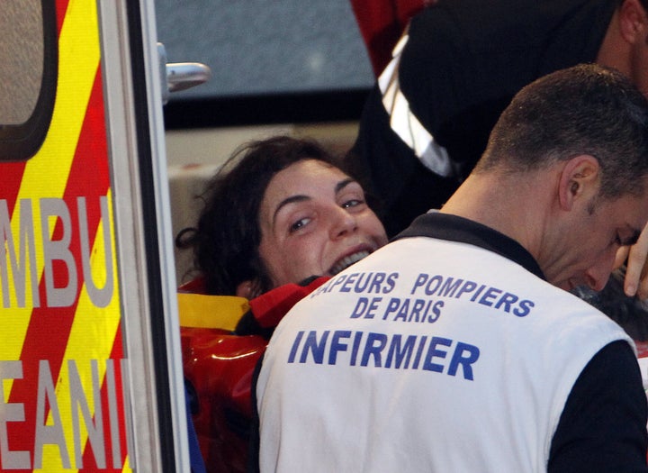 French journalist Edith Bouvier smiles as firefighters carry her into an ambulance after the plane carrying her and French photographer William Daniels landed at the military aiport of Villacoublay outside Paris on March 2, 2012. Bouvier, 31, and Daniels, 34, escaped to Lebanon after being trapped for days under bombardment in the flashpoint Syrian city of Homs. Le Figaro newspaper reporter Bouvier has multiple fractures from a Feb. 22 rocket attack on a rebel makeshift media centre in Baba Amr in Homs in which veteran U.S. reporter Marie Colvin and French photographer Remi Ochlik were killed. Another journalist wounded in the attack, British photographer Paul Conroy, was evacuated to Lebanon on Feb. 28, 2012.