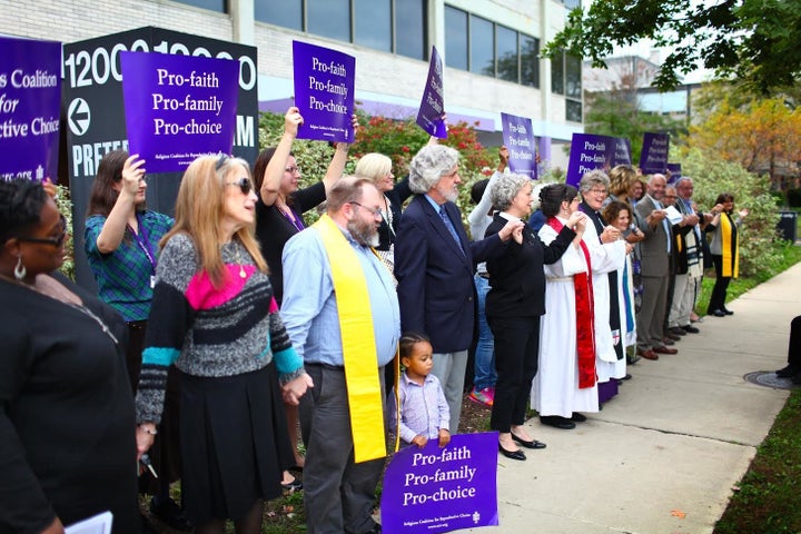 Clergy members and others stand outside the Preterm abortion clinic in support of the pro-choice movement. 