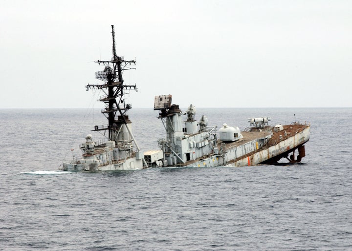 The decommissioned USS Towers, an old destroyer, slowly sinks in the Pacific Ocean after being used as a target for live-fire sinking exercises.