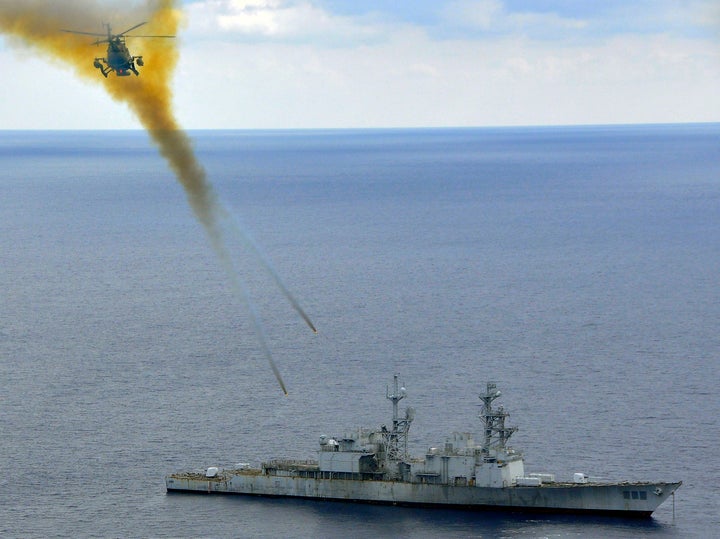 A Mexican helicopter fires explosive rockets at the ex-USS Conolly during a sinking exercise in 2009.