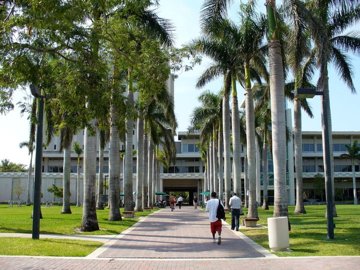 Students walk outside of a library on the University of Miami campus. The school is being sued by a former graduate student who says it failed to properly investigate her sexual harassment case.