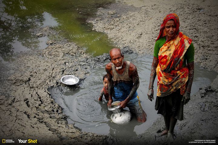 In "Victim of Climate Change," a family collects clean water from under the soil in Kayra, Bangladesh, a region frequently tormented by natural disasters like tornadoes, cyclones and floods.