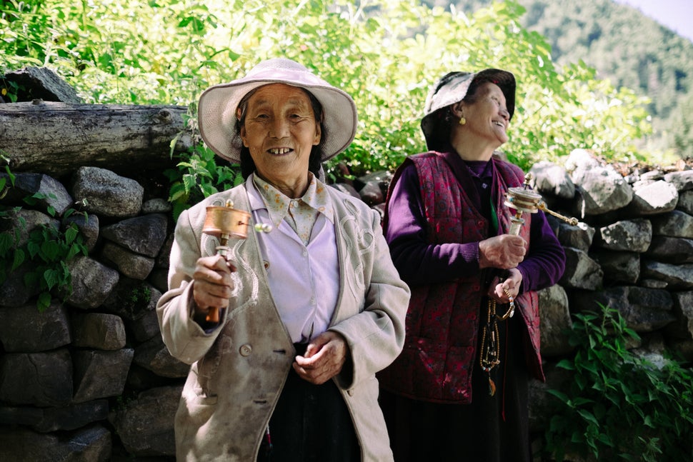 A woman spins a prayer wheel in Wenping village.