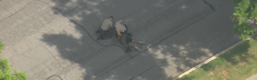 News footage shows two deputies attempting to put a suspect in handcuffs after a high-speed chase in Southern California.