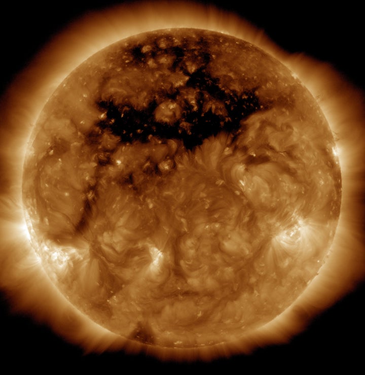 The dark area across the top of the sun in this image is a coronal hole. High-speed solar wind originating from the hole created a geomagnetic storm near Earth that resulted in several nights of auroras.