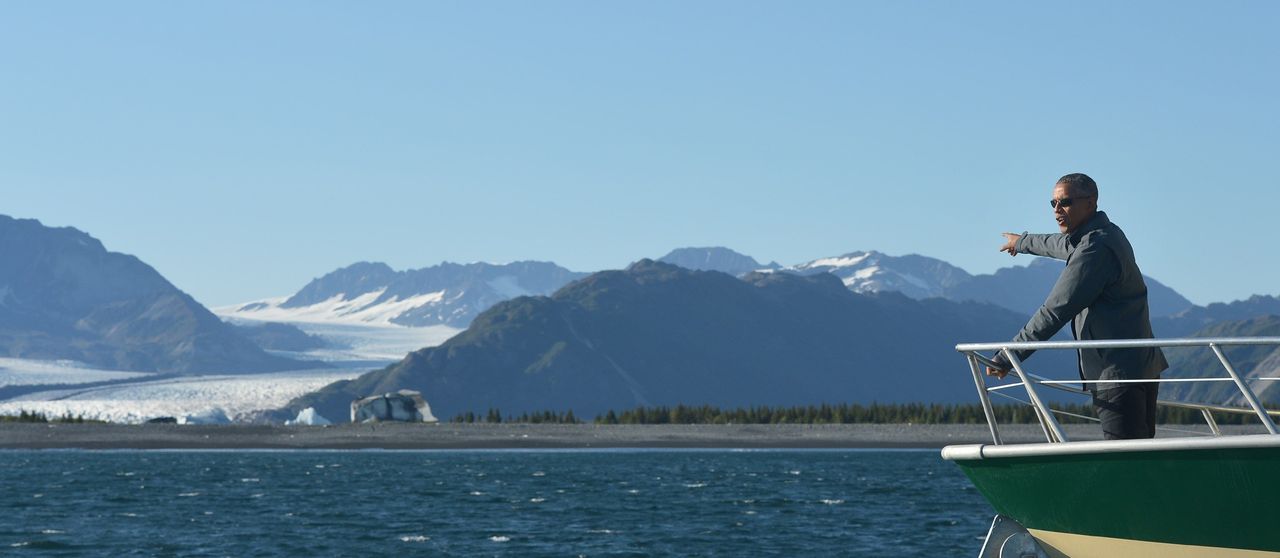 President Obama points to Bear Glacier during a boat tour of the Kenai Fjords National Park in Seward, Alaska.