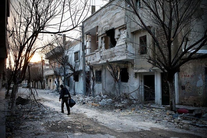 A boy walks amid destruction in the district of Baba Amr in Homs in February 2012.