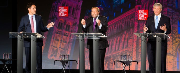 Justin Trudeau, leader of the Liberal Party of Canada, left, Thomas "Tom" Mulcair, leader of the New Democratic Party, center, and Conservative leader Stephen Harper, Canada's prime minister, speak during a debate on Thursday, Sept. 17, 2015. Canada's political system has the drawback of vote splitting.