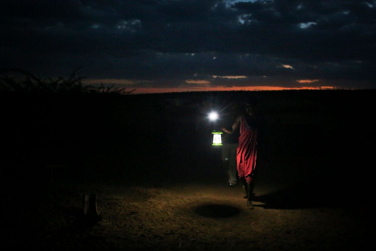 A Masaai man holds up a newly obtained solar lamp to keep predators away from the herds. The Masaai are at the center of innovations in renewable energy. 
