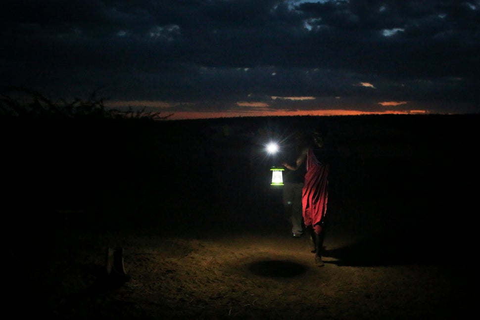 A Masaai man holds up a newly obtained solar lamp to keep predators away from the herds. The Masaai are at the center of inno
