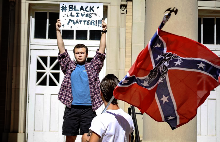 An Ole Miss student responds to a KKK counter-rally on campus with a "Black Lives Matter" sign.