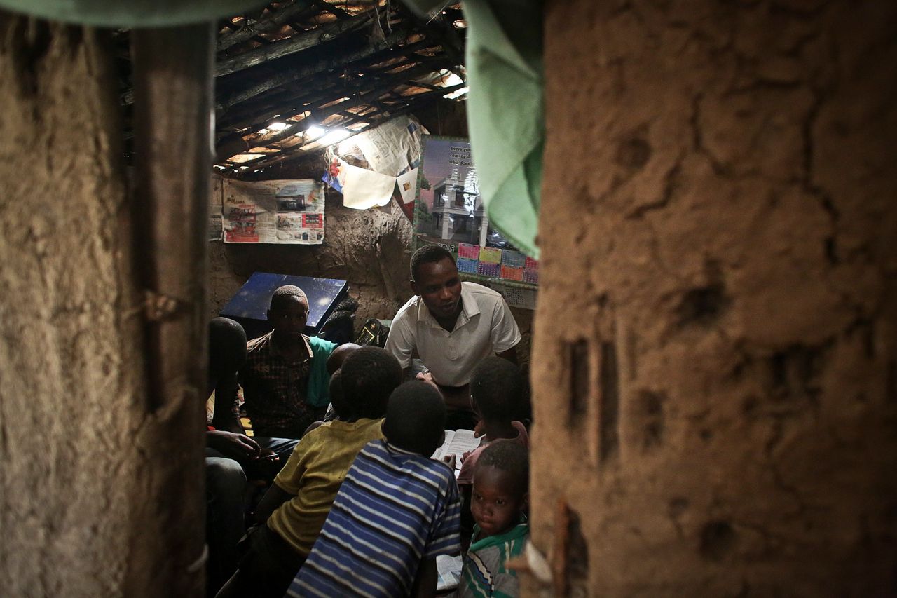 John Keko Mututua, 16, studies with children from the village in his small hut in the town of Suswa, Kenya. Power provides myriad opportunities, both large and small, to rural parts of Africa. 