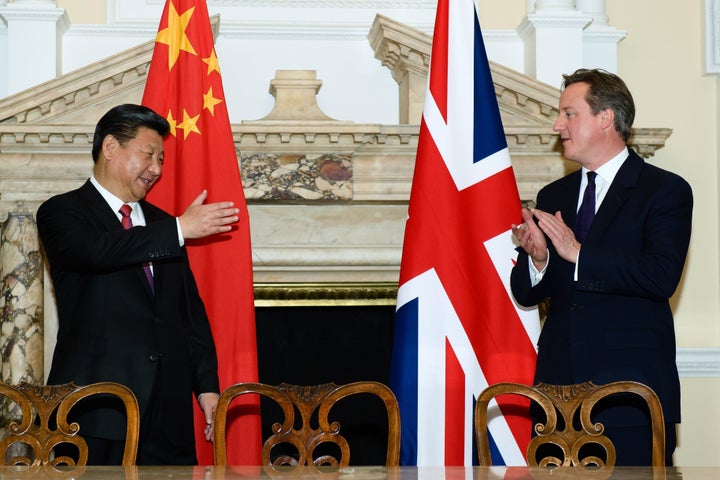 Chinese President Xi Jinping and British Prime Minister David Cameron celebrate the Chinese leader's four-day visit to the U.