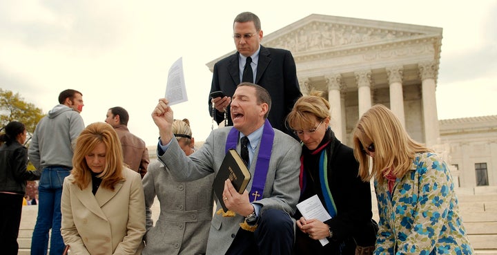 The Rev. Robert Schenck leads anti-abortion advocates in prayer on the steps of the Supreme Court on April 18, 2007.