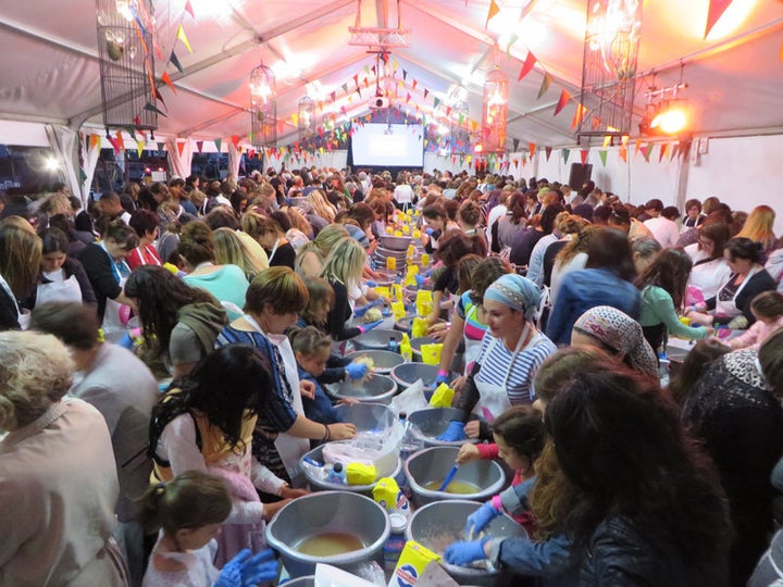 More than 1,700 Jewish women knead dough under a tent during the Great Big Challah Bake on Wednesday (Oct. 21, 2015) in Cape