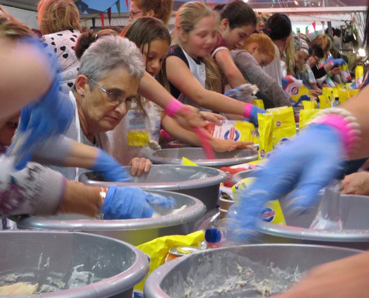 More than 1,700 Jewish women knead dough under a tent during Wednesday (Oct. 21, 2015) night's Great Big Challah Bake in Cape