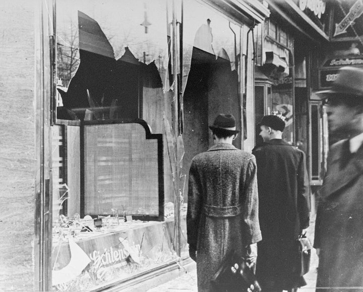 Germans pass by the smashed windows of a Jewish-owned shop. The aftermath of Kristallnacht (Night of Broken Glass) 9-10 November 1938, the German anti-semitic pogrom , when over 200 Synagogues were destroyed and thousands of Jewish homes and businesses were ransacked.