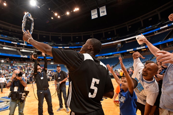 The Orlando Magic's Victor Oladipo poses for a "Twitter Mirror" photo with fans during an open practice on Oct. 5, 2015. 