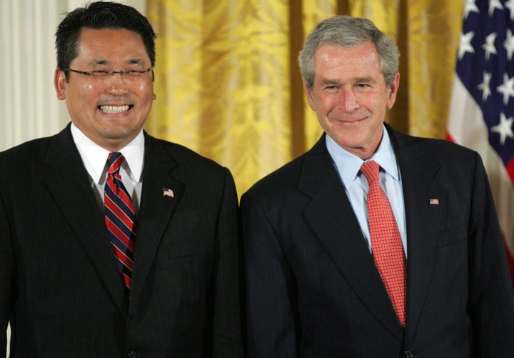 US President George W. Bush smiles alongside Kay Hiramine, CEO of Private Sector Consulting in Colorado Springs, Colorado, pr