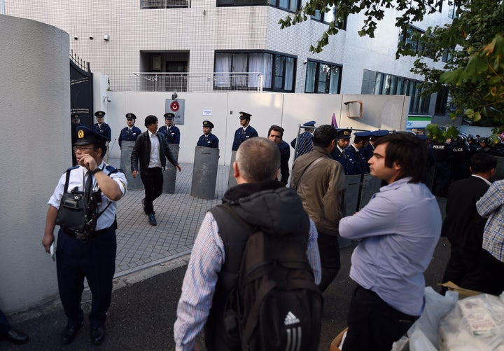 Riot police officers stand guard in front of the Turkish embassy in Tokyo on October 25, 2015.