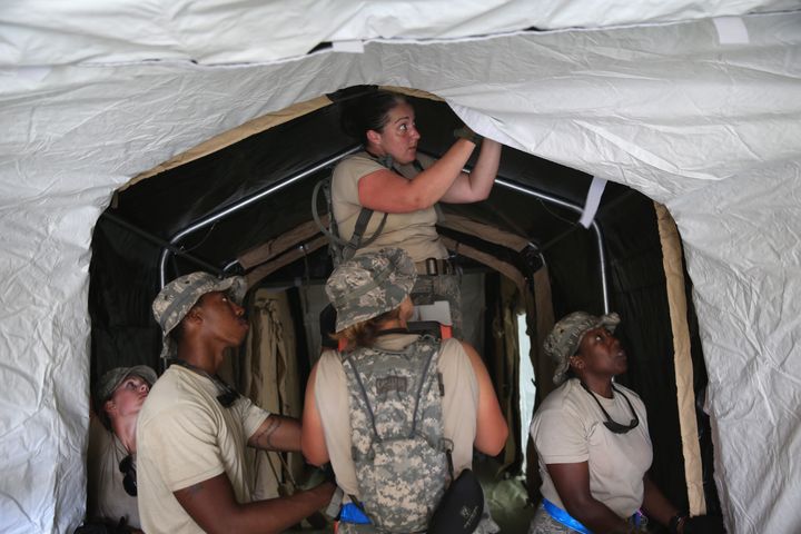 MONROVIA, LIBERIA - OCTOBER 08: U.S. Air Force personnel work to set up a 25-bed hospital to aid Liberian health workers infected with Ebola on October 8, 2014 near Monrovia, Liberia. 