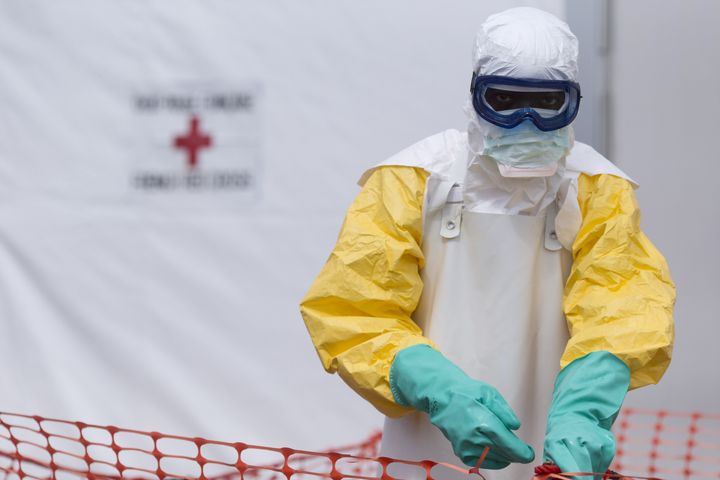 A health worker wearing a personal protective equipment (PPE) works at the Ebola treatment center run by the French red cross society in Macenta in Guinea on November 20, 2014.