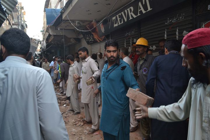 People remove debris in the Sargodha district of Punjab province in Pakistan. 