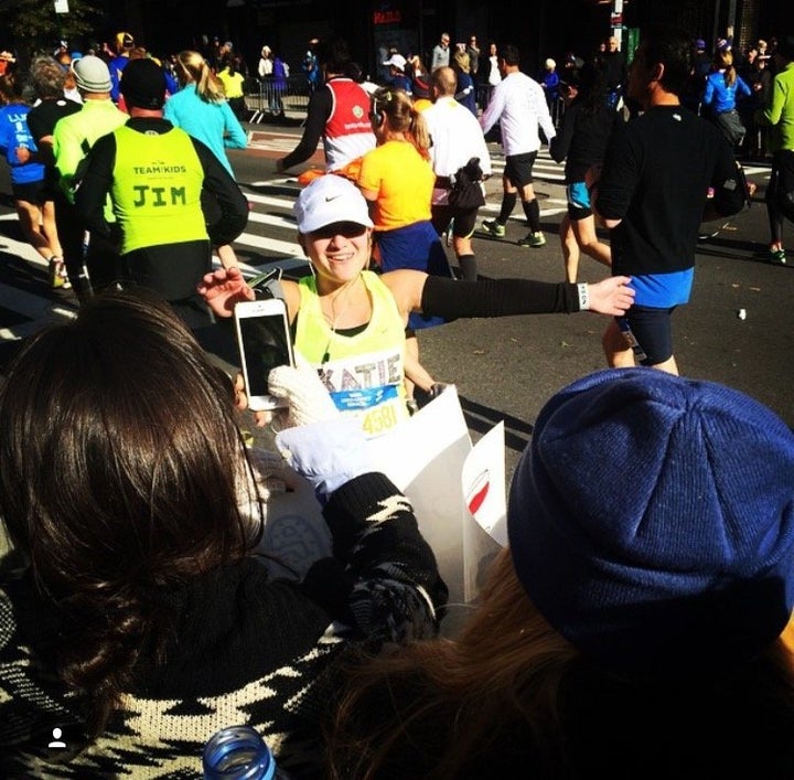 Caba finds friends and family in the crowd of the 2014 marathon.