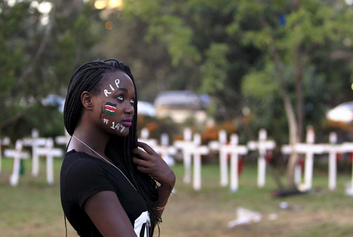 A student wearing face paint walks past wooden crosses in memory of the Garissa university students who were killed by gunmen, at a memorial concert at the “Freedom Corner” in Kenya’s capital Nairobi on April 14, 2015.